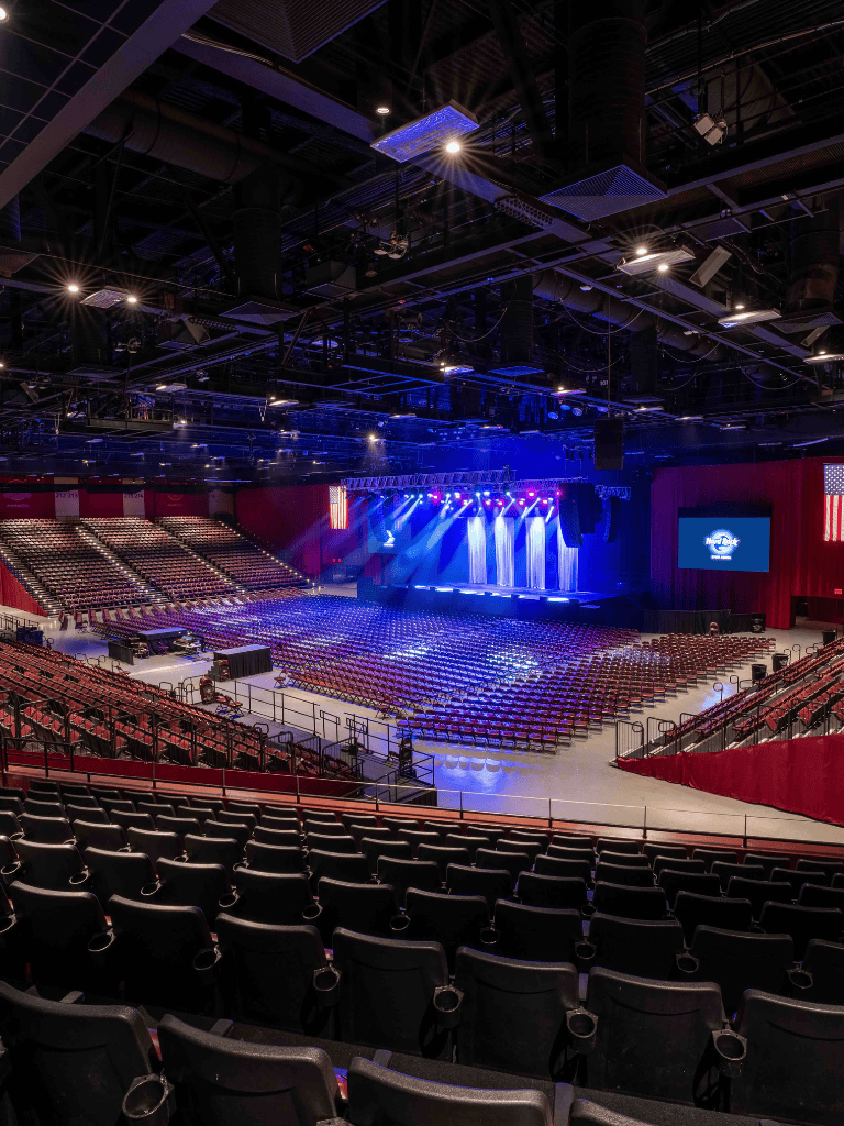 Modern concert arena with stage and seating for large events.