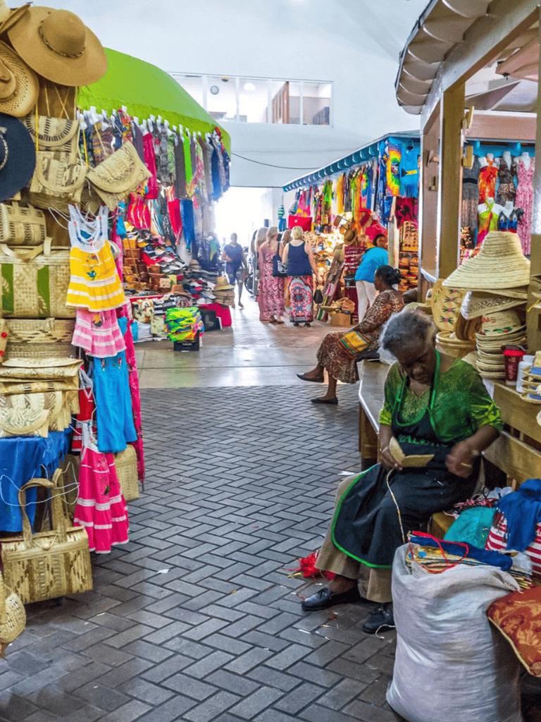 Colorful market stall with handmade crafts and textiles, vibrant local shopping experience, indoor marketplace.