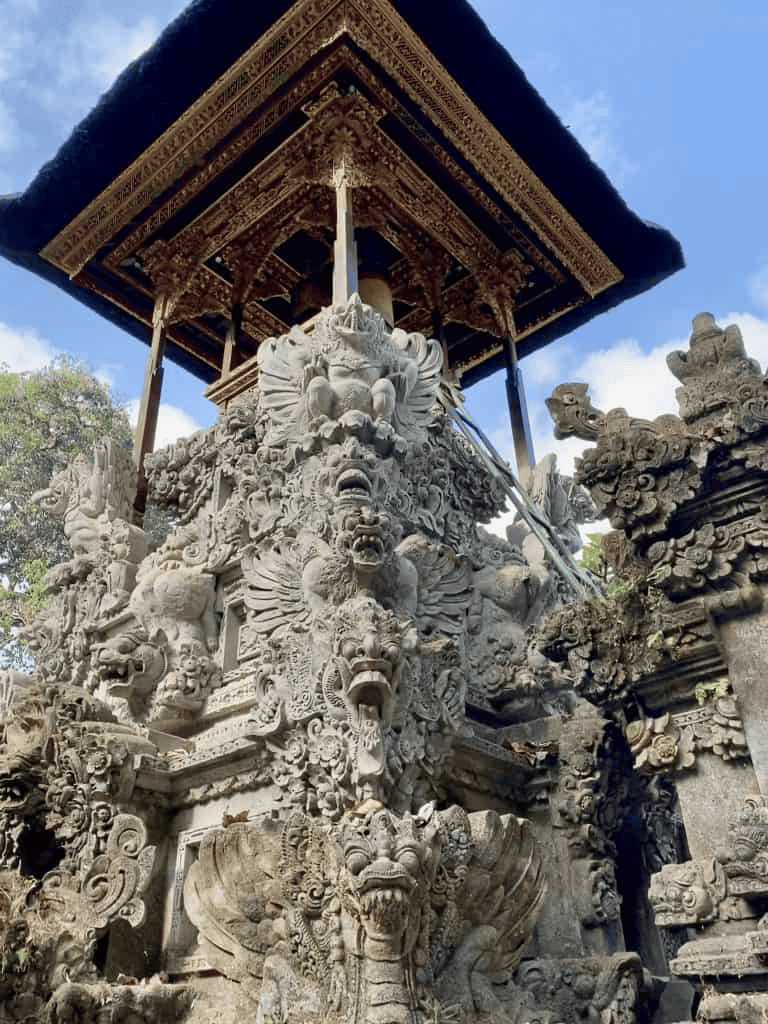 Intricate stone carvings of temple guardian statues at QuestForDirections Indonesia travel site.