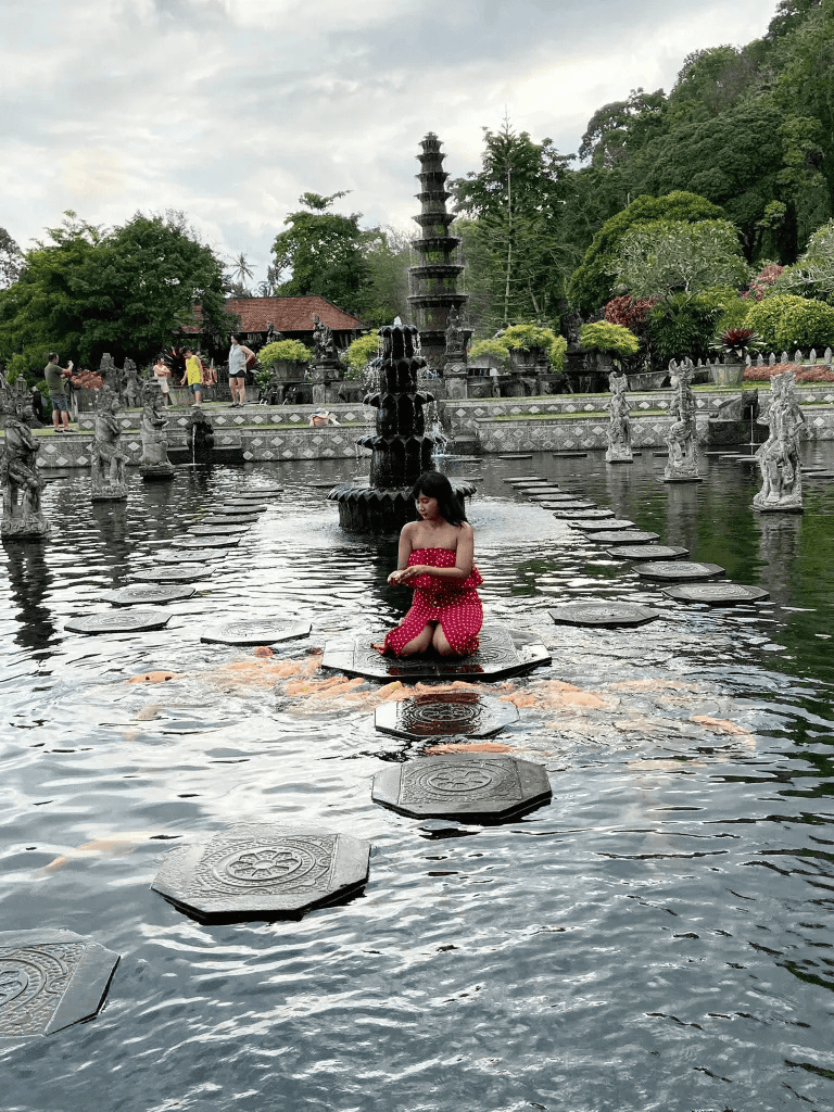 Tranquil fountain garden with stepping stones and visitors at QuestForDirections.