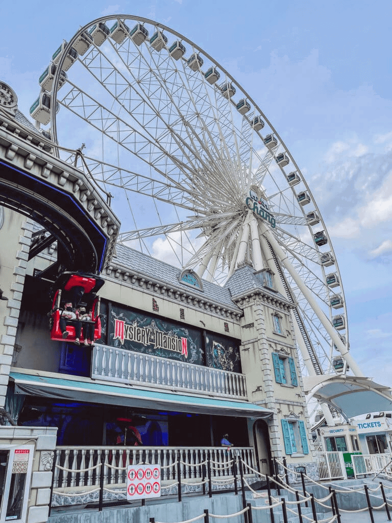 Bright Ferris wheel at Quest for Directions amusement park, offering fun rides and attractions.