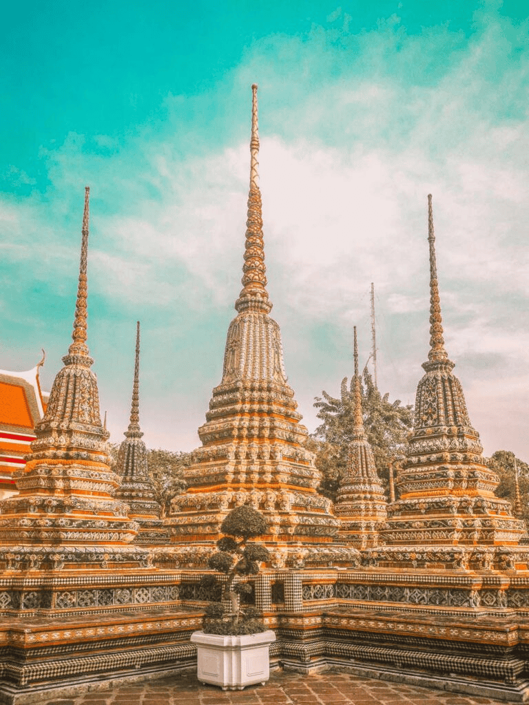 Intricate Thai temples with ornate decorations and towering spires, showcasing cultural heritage.