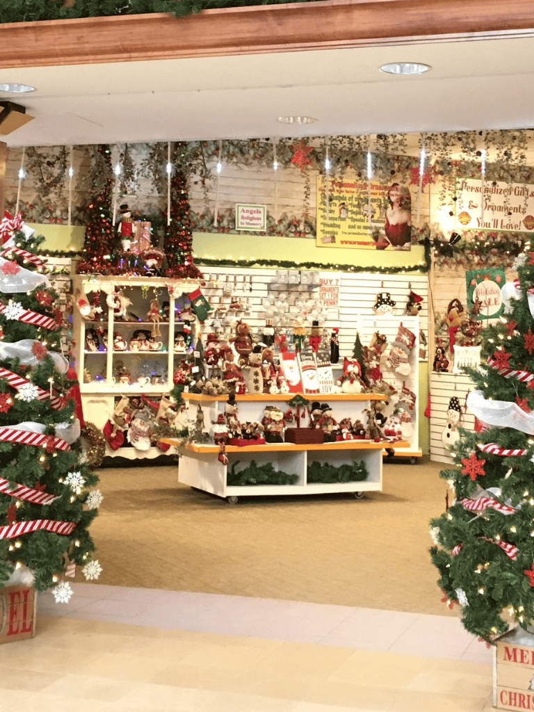 Colorful Christmas store display with holiday decorations and ornaments.