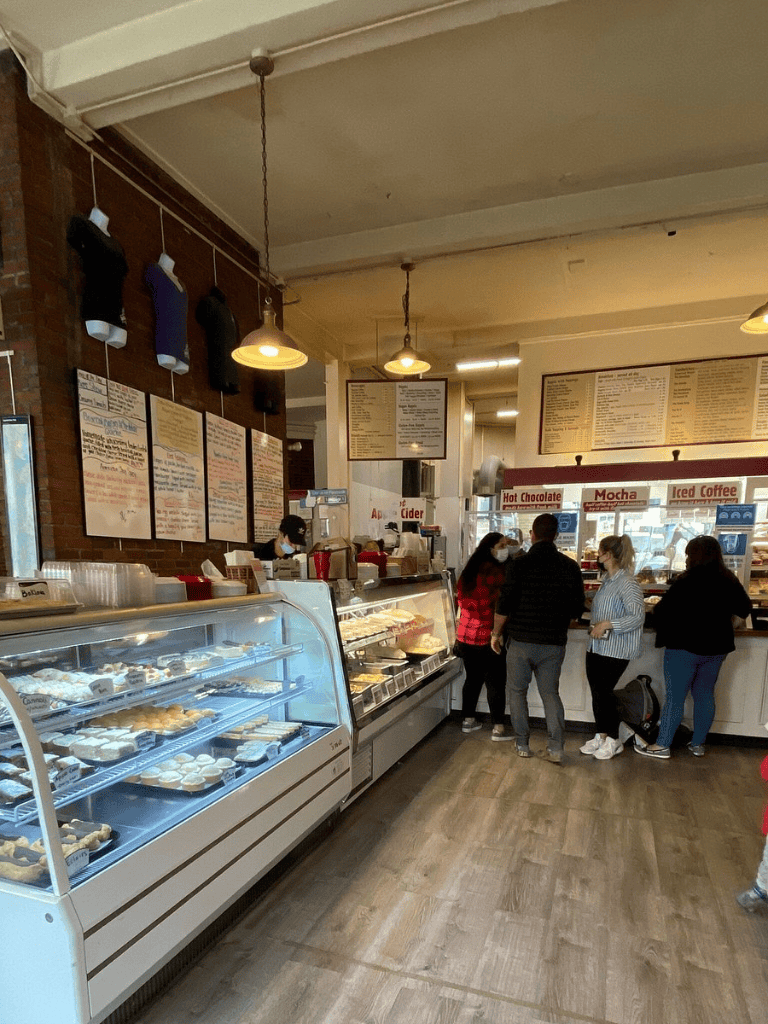 Fresh baked goods and coffee counter at QuestForDirections café, a cozy spot for breakfast and snacks.