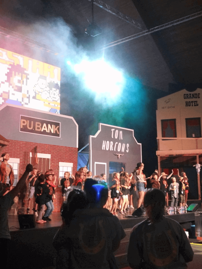 Characters performing in the Quest for Directions theatrical show, enhancing audience engagement.