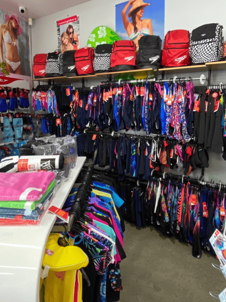Beachwear and swim accessories display at QuestForDirections store, perfect for summer vacations.
