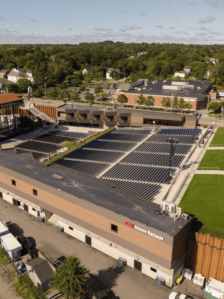 Renewable energy solar panels on school rooftop for green campus sustainability.