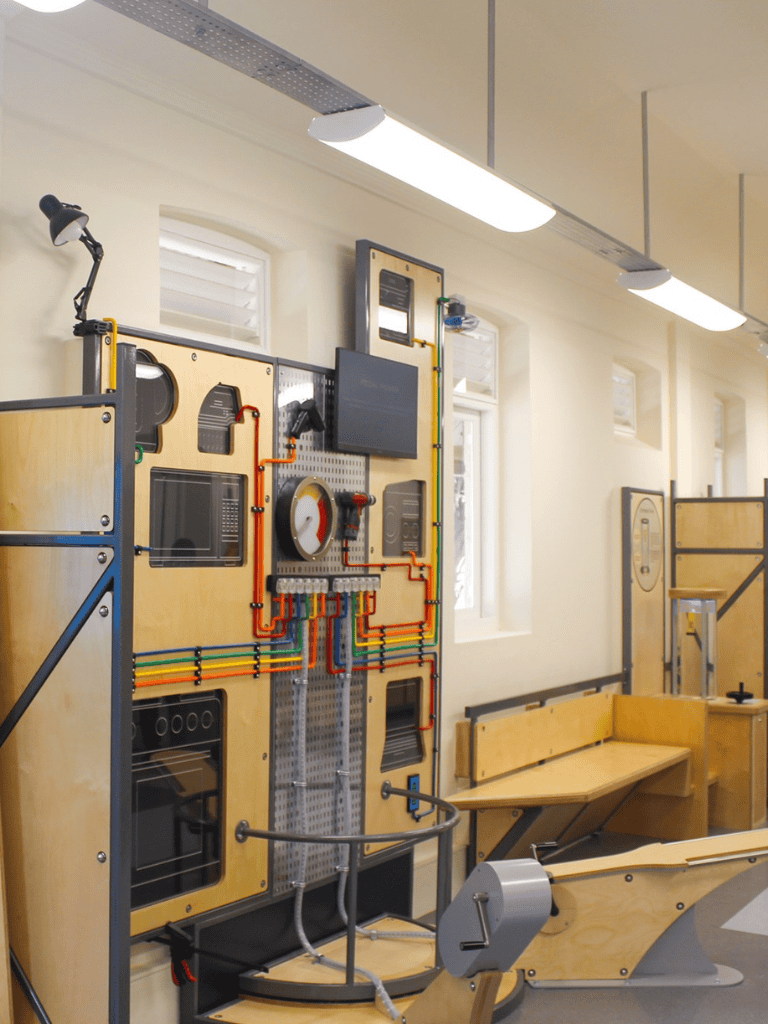 Electrical engineering educational exhibit with circuit panels and interactive components.