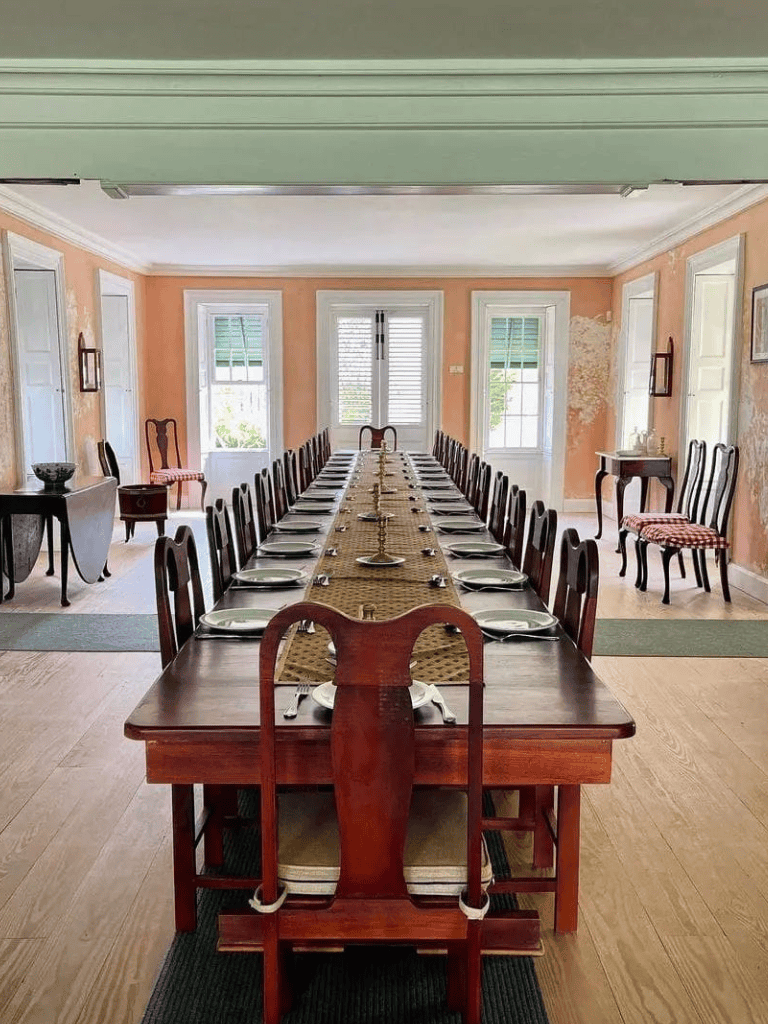 Stately dining room setup with elegant antique furniture and a long, formal table for special occasions.