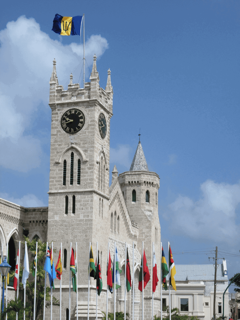Historic clock tower with flags, Bahamas landmark, Caribbean tourism attraction, scenic architecture of Nassau.