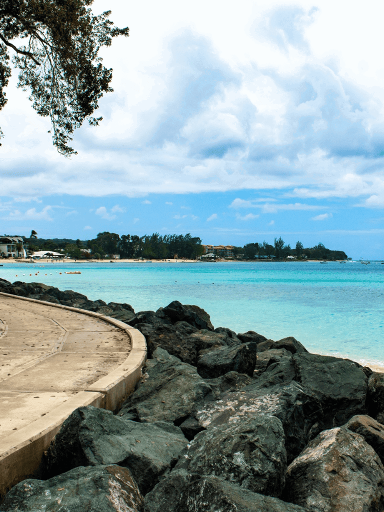 Relaxing beach with rocky shoreline and scenic ocean view, perfect for coastal navigation and travel planning.
