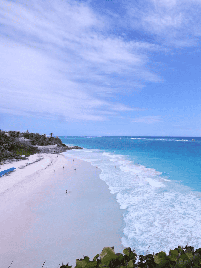 Seaside beach with turquoise waters and blue sky, scenic ocean view, tropical coast, relaxing coastal scenery.