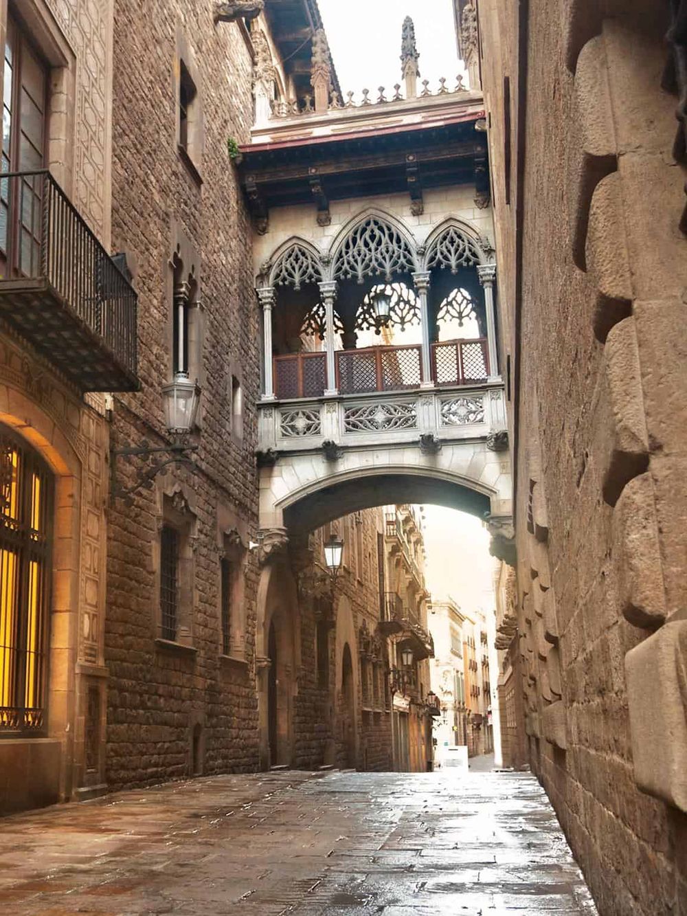Beautiful historic alleyway with Gothic architectural bridge connecting buildings in Barcelona. Perfect for exploring Catalan culture.