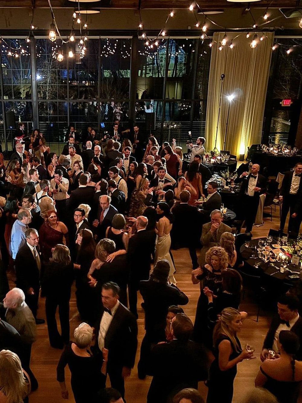 Elegant corporate event or wedding reception in a modern venue with upscale ambiance and stylish lighting.