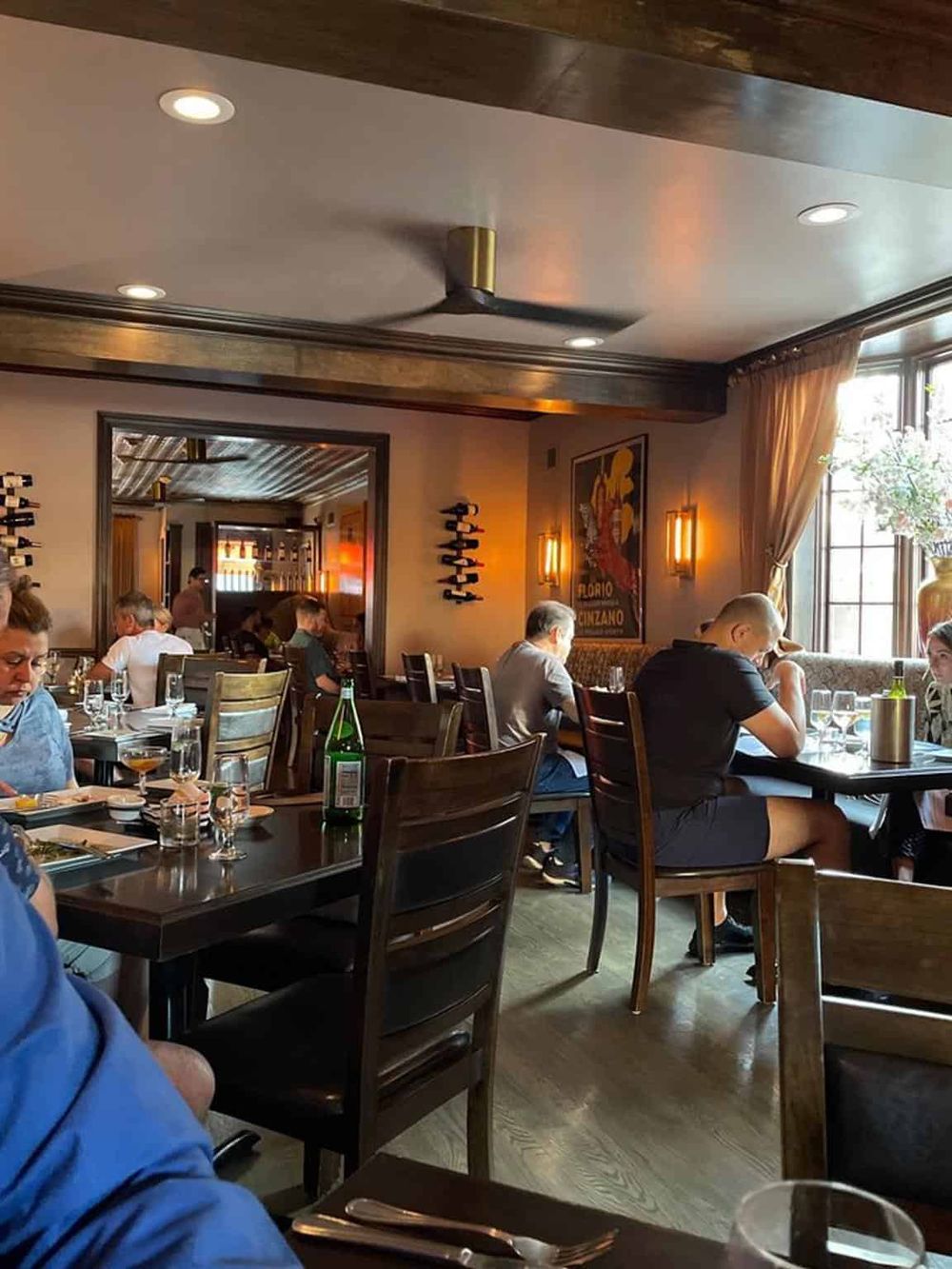 Cozy restaurant interior with stylish decor, natural lighting, and diners enjoying meals, embodying a welcoming dining experience.