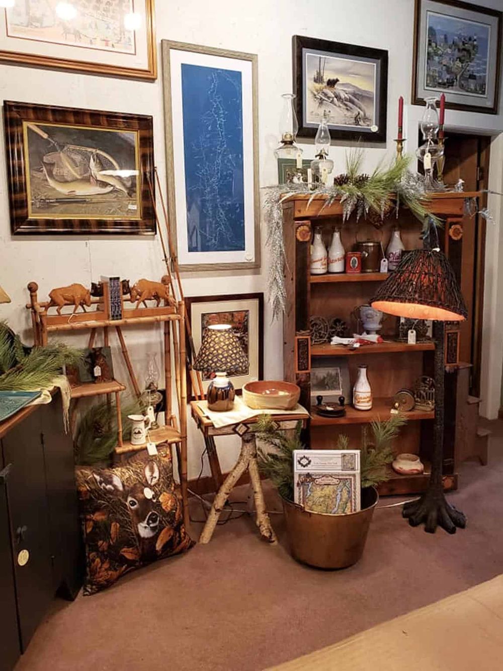 Vintage home decor with framed artwork, wooden shelves, and rustic accents, creating cozy interior design.