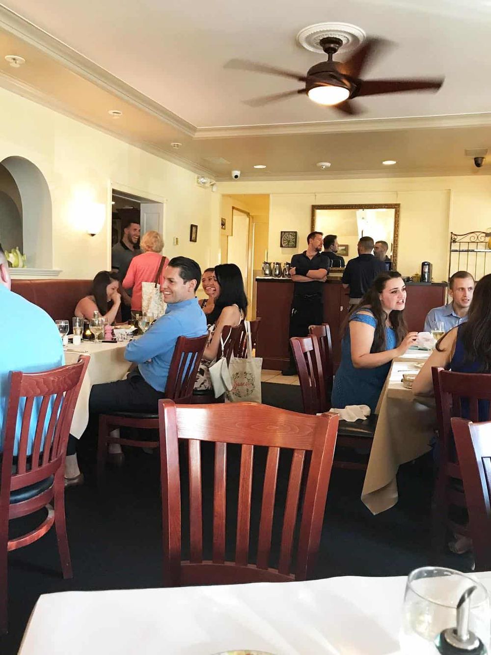 Happy diners enjoying a meal at QuestForDirections restaurant, a popular dining spot offering excellent service and delicious food.