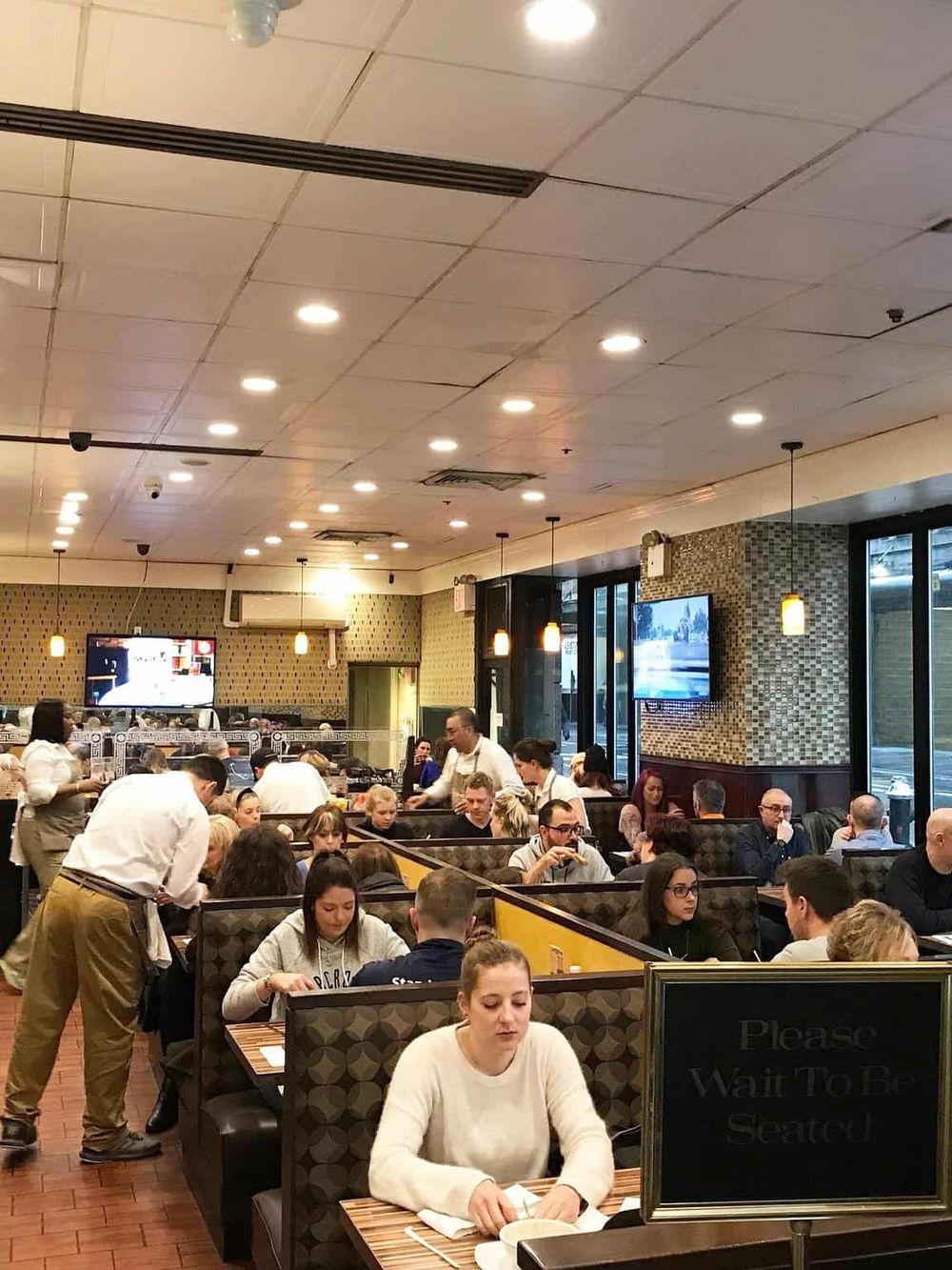 Busy restaurant interior with diners, emphasizing hospitality and dining experience at QuestForDirections.