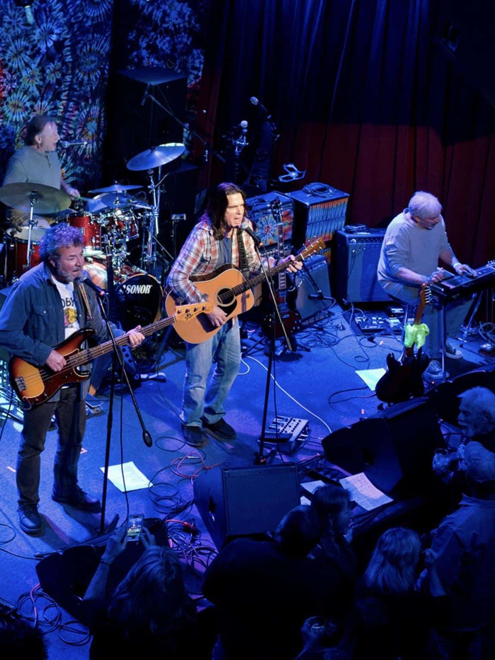 Live band performance at Quest for Directions music venue, showcasing talented musicians on stage.