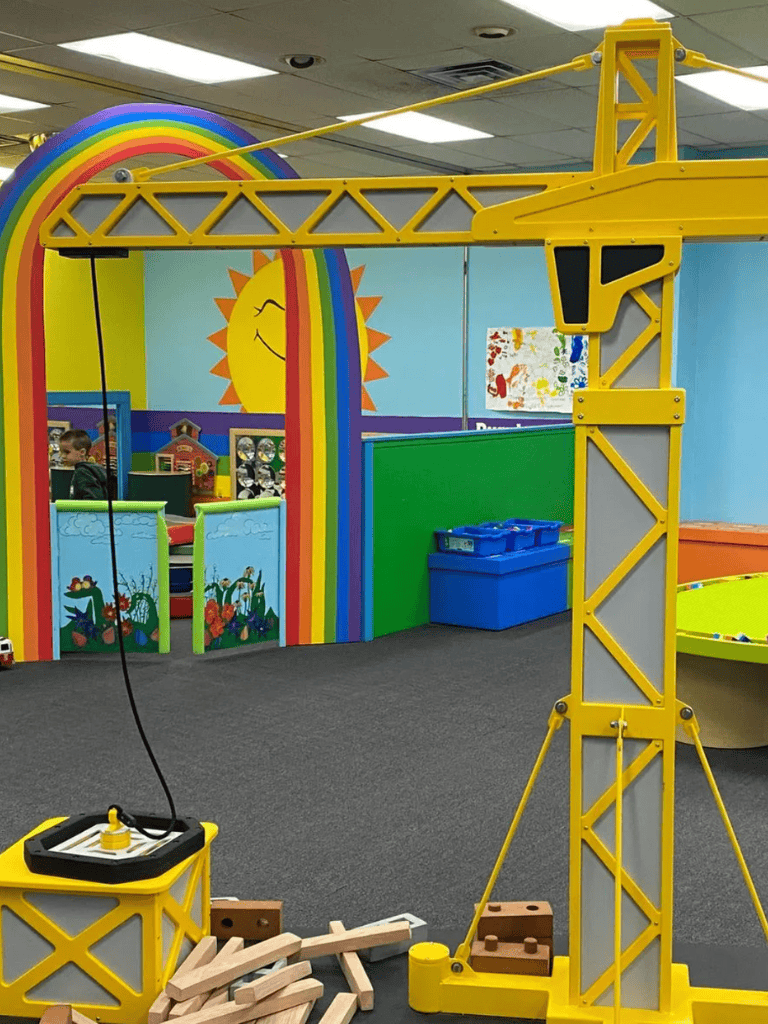 Caterpillar construction toy set for kids with colorful play area and murals.