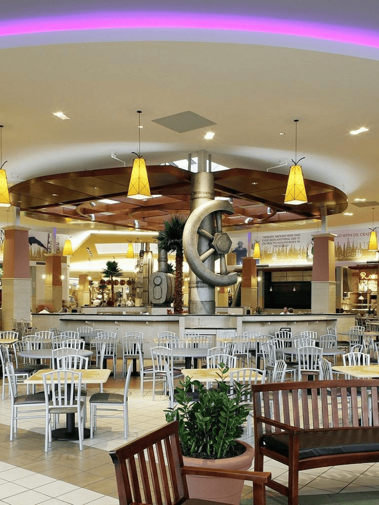 Modern indoor dining area with stylish seating and decorative central sculpture at QuestForDirections.