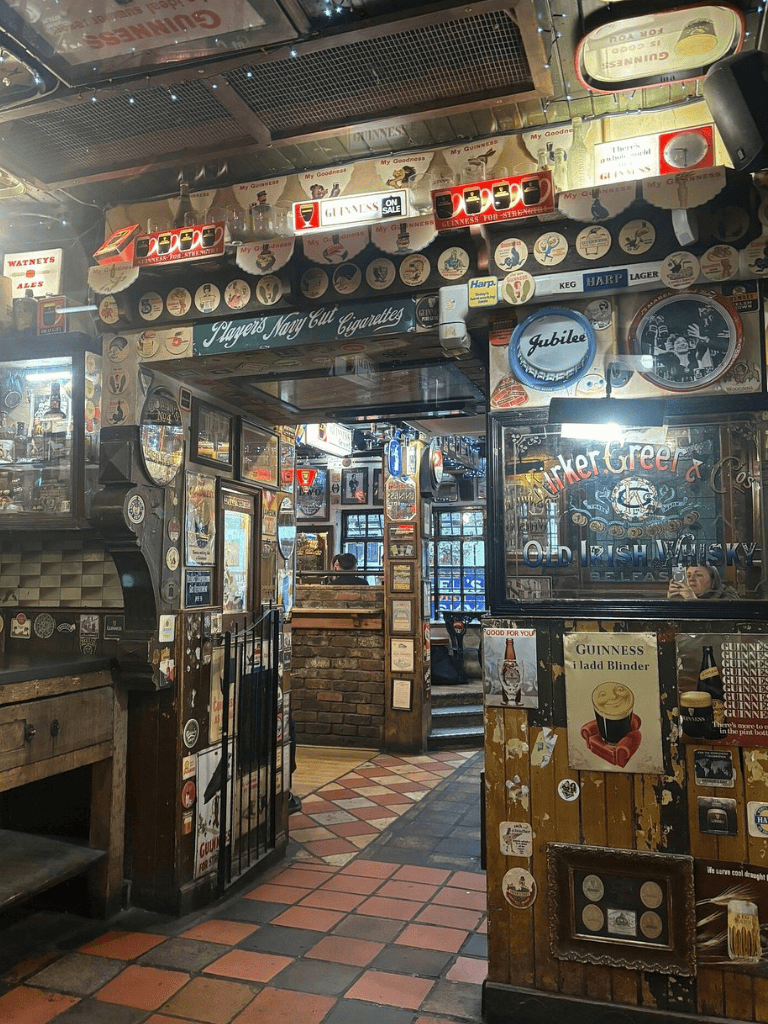 Guinness pub interior with vintage decor and beer memorabilia.