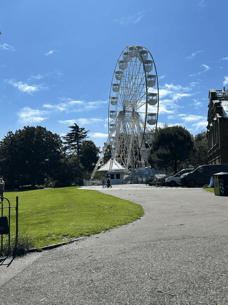 Ferris wheel at Quest for Directions amusement park, outdoor fun and rides in the city.
