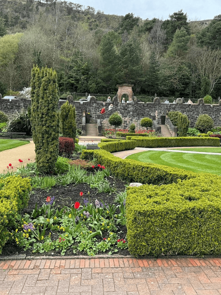 Colorful garden and stone sculptures at Quest for Directions historic site outdoor park visiting area.