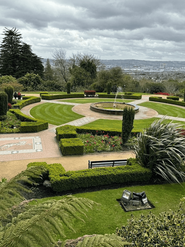 Vibrant park with manicured landscaping and a central fountain, ideal for outdoor relaxation and scenic views.