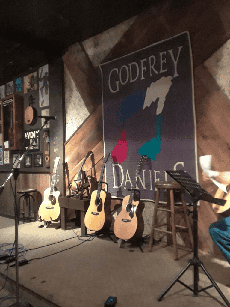 Goderoy Daniel musical performance with acoustic guitars at QuestForDirections event.