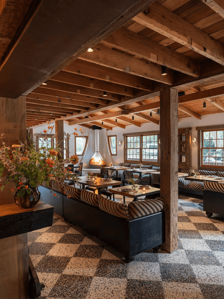 Cozy restaurant interior with wooden beams and checkered flooring, perfect for dining and socializing.