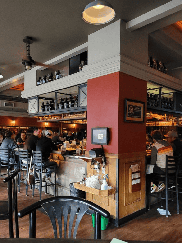 1. Modern brewery bar interior with patrons enjoying drinks and socializing.