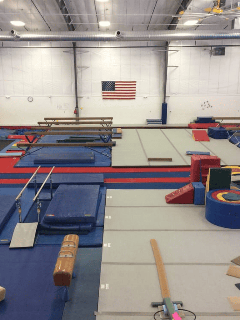 Gymnastics training facility interior with mats and equipment in the USA.