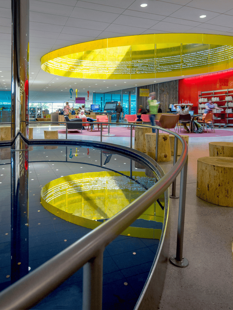 Bright modern library interior with colorful decor and seating areas for reading and studying.