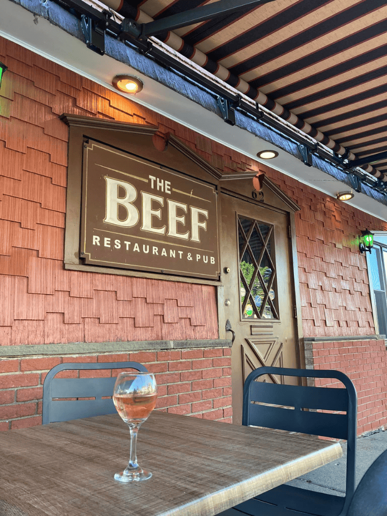 Enjoying outdoor dining at The BEEF Restaurant & Pub with a glass of rosé.