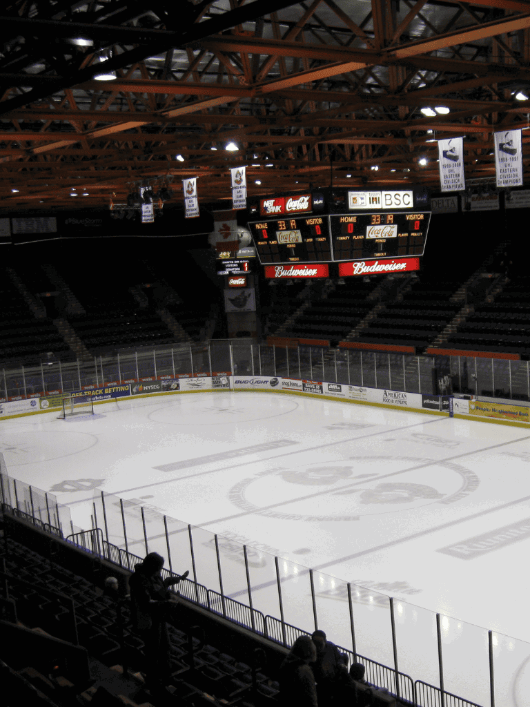 Empty hockey arena with scoreboard and ice rink at QuestForDirections sports venue.