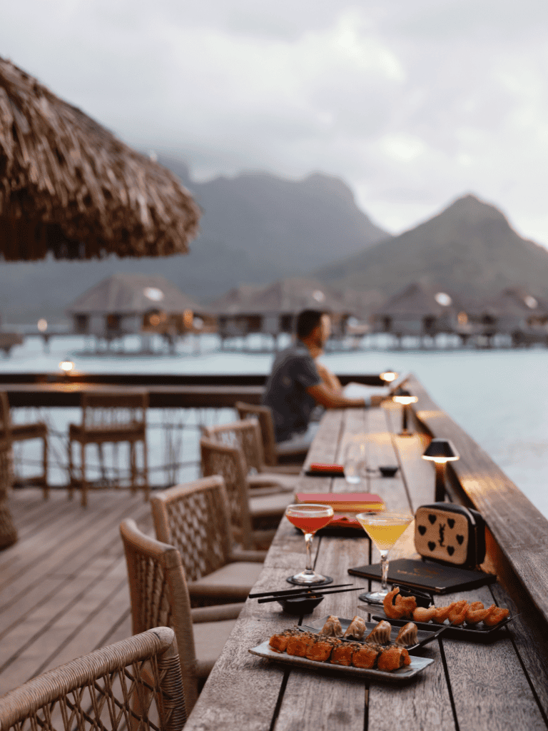 Relaxing waterfront dining with drinks, sushi, and mountain views at QuestForDirections.