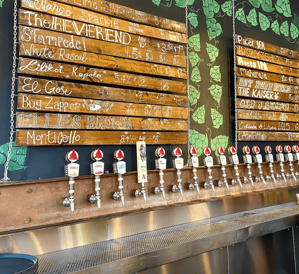 1. Colorful craft beer taps with a chalkboard menu at a brewery or taproom.