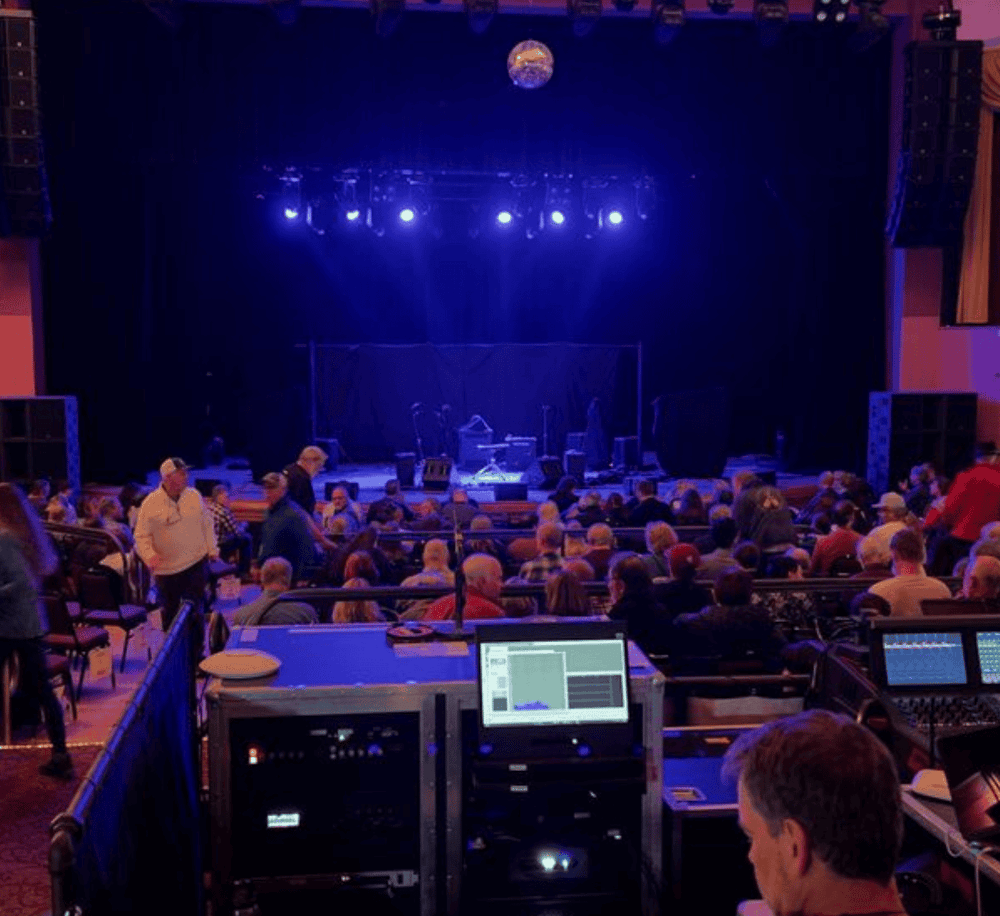 Live entertainment stage with audience at QuestForDirections event venue.