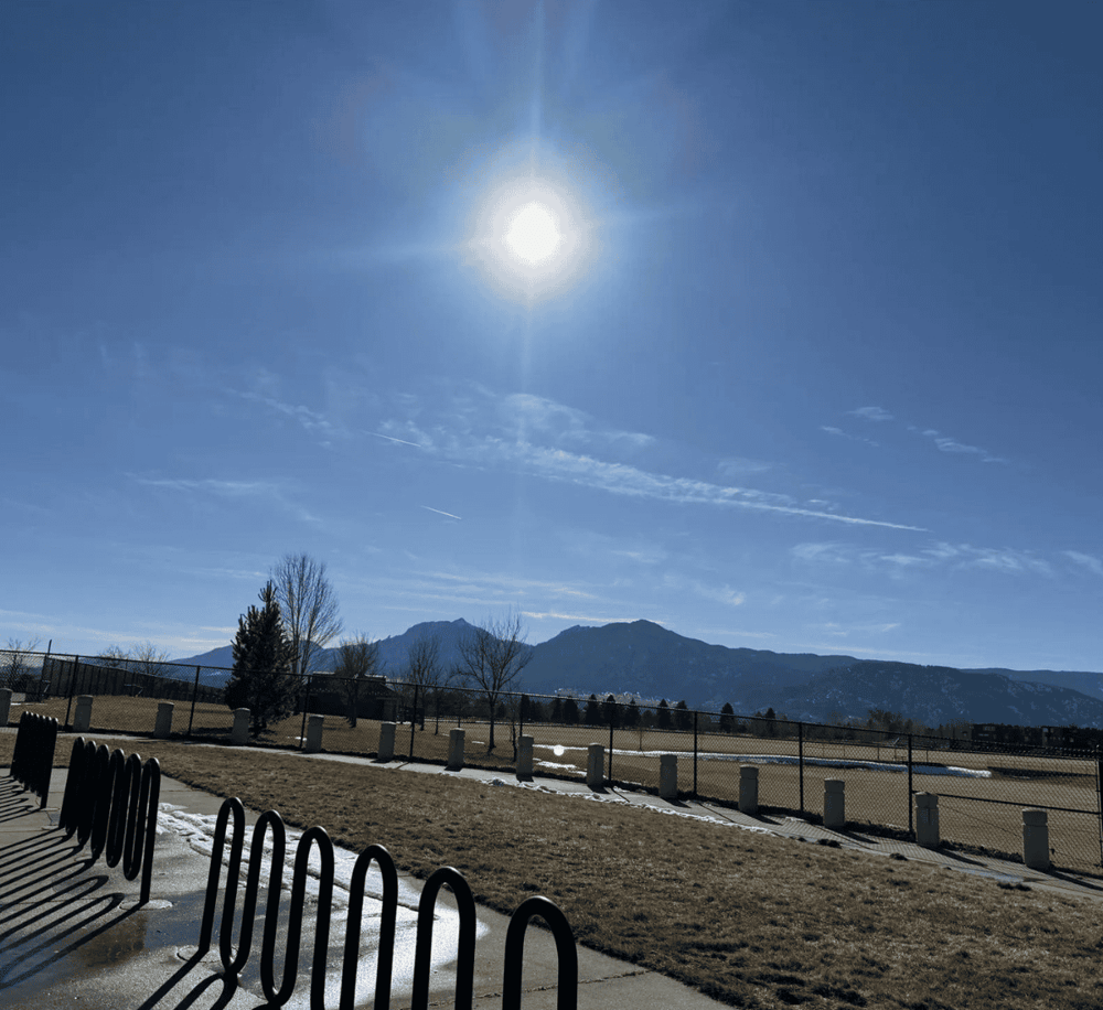 Bright sunny day at QuestForDirections campus with mountains in the background.
