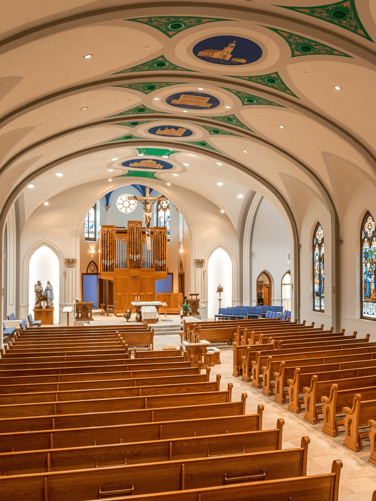 Ornate church interior with wooden pews, stained glass windows, and religious artwork for spiritual guidance.