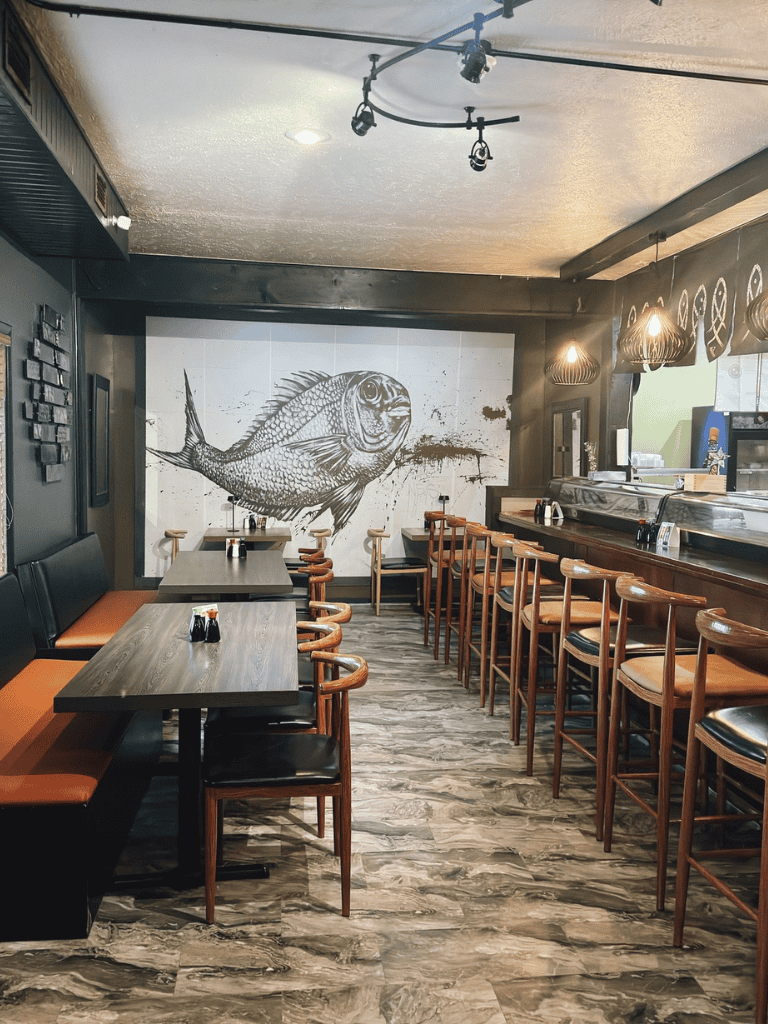 1. Modern seafood restaurant interior with fish wall art and cozy seating.