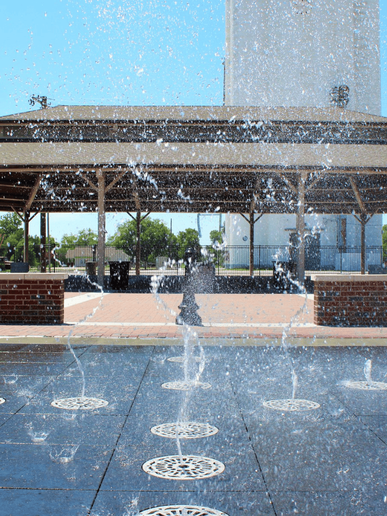 Fountain with water jets under a pavilion at QuestForDirections outdoor location.