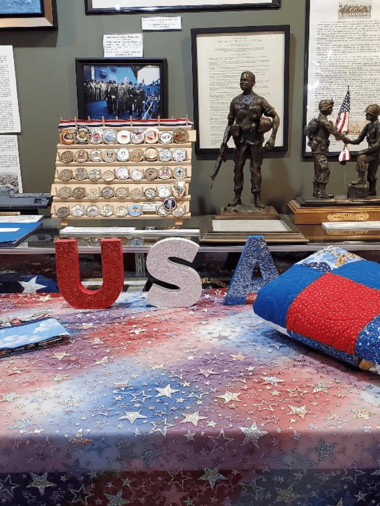 USA patriotic memorabilia and military figurines display at QuestForDirections exhibit.