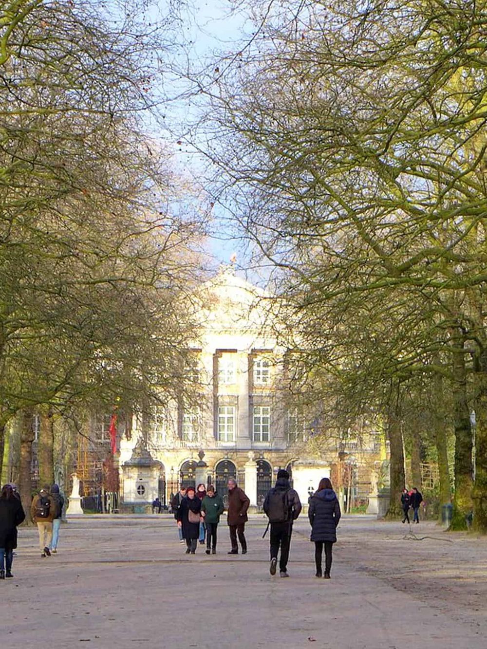 Historic city park with people walking and exploring, perfect for outdoor adventures and urban exploration.
