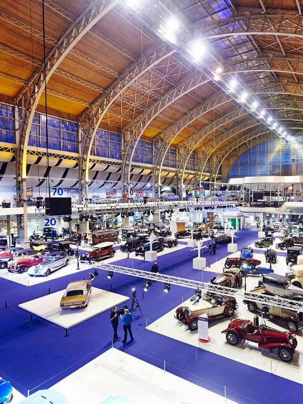 Vintage car exhibit at QuestForDirections auto museum, showcasing rare classic vehicles in an expansive indoor venue.