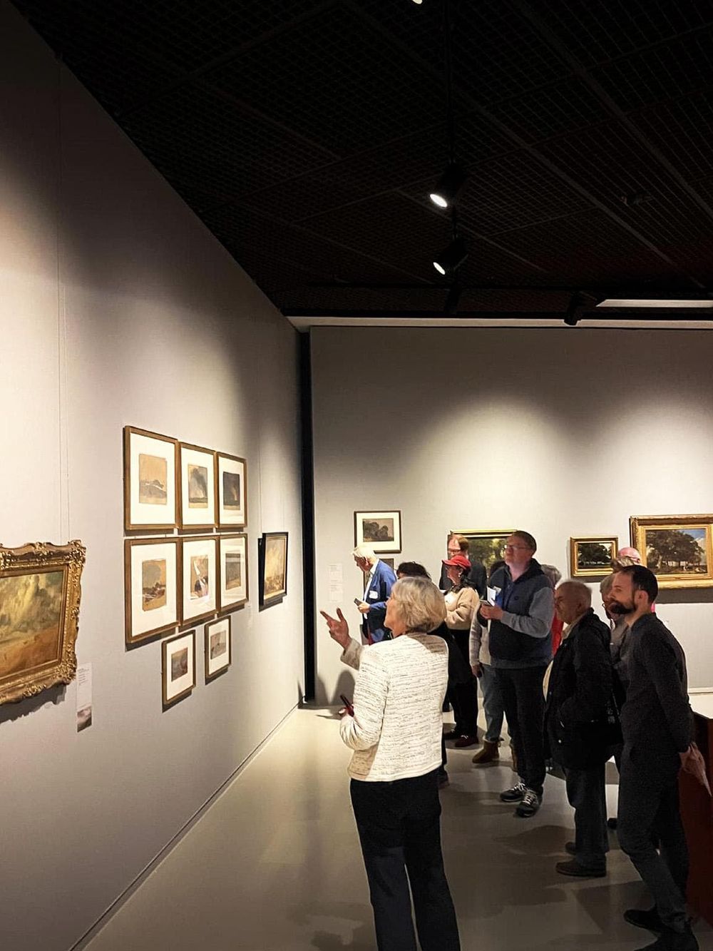 Vibrant art gallery showcasing diverse landscape paintings at QuestForDirections museum.