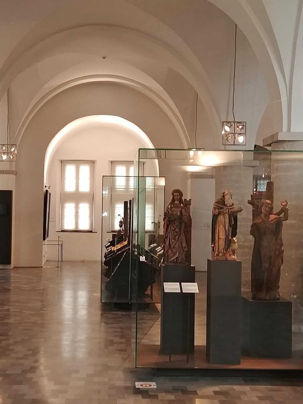 Intricate religious statues and art pieces displayed in a museum exhibit, showcasing historical and cultural significance.