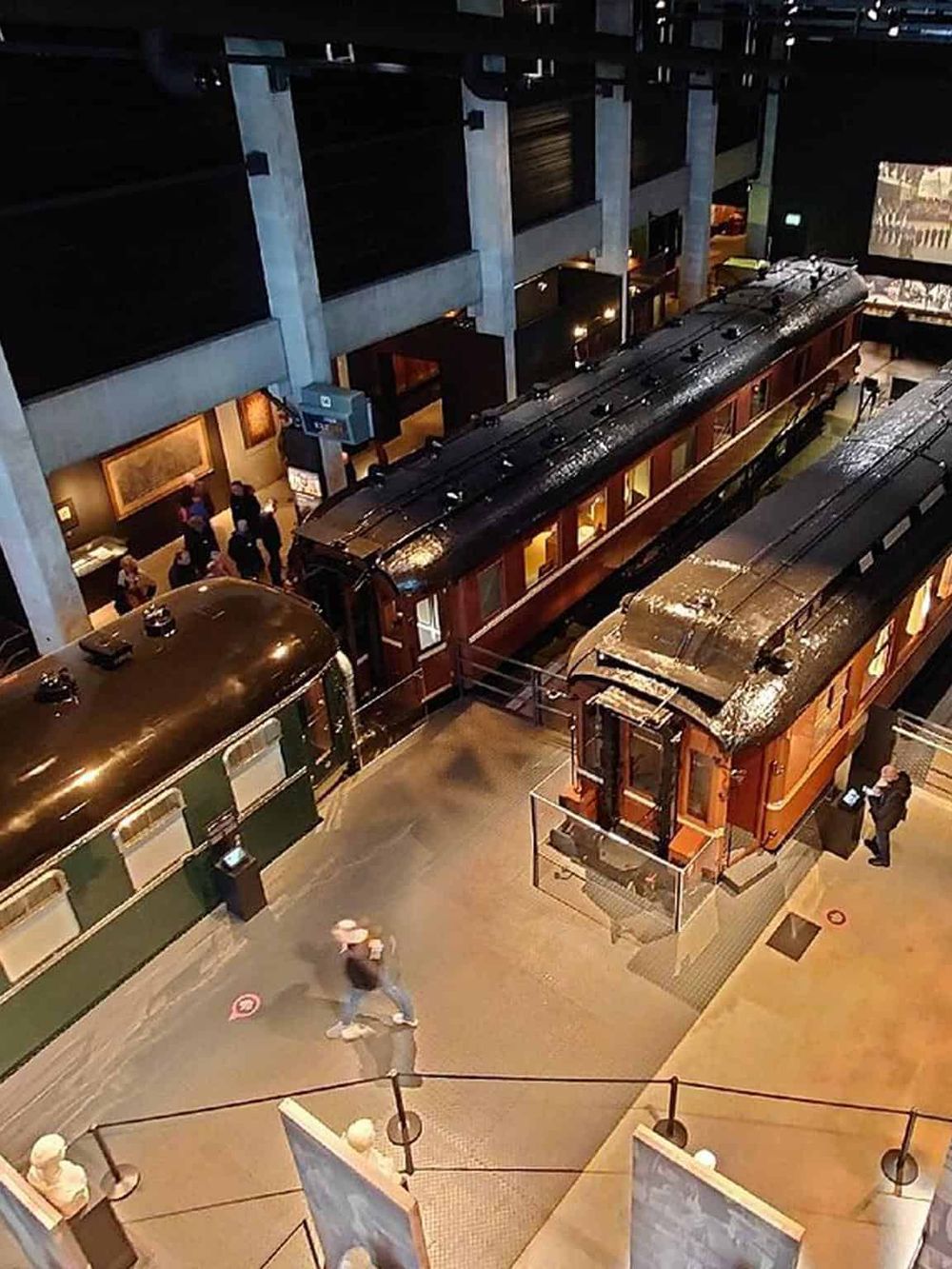 Vintage train exhibit inside a modern museum setting.
