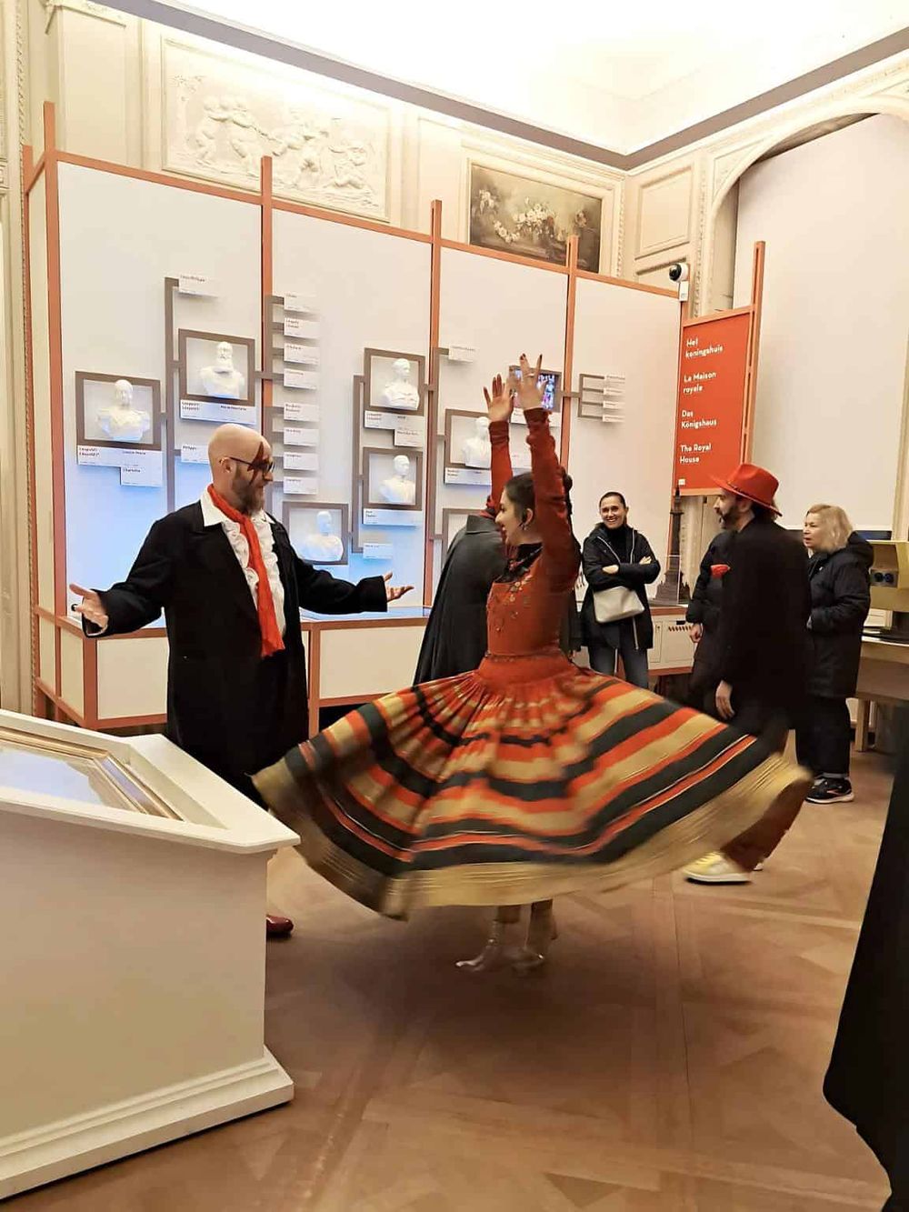 Colorful traditional dancers performing at a cultural exhibit, showcasing art, history, and entertainment.